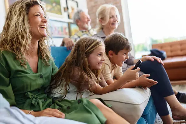Extended family happily watching a movie streamed through Kyro Player with Xtream Codes credentials