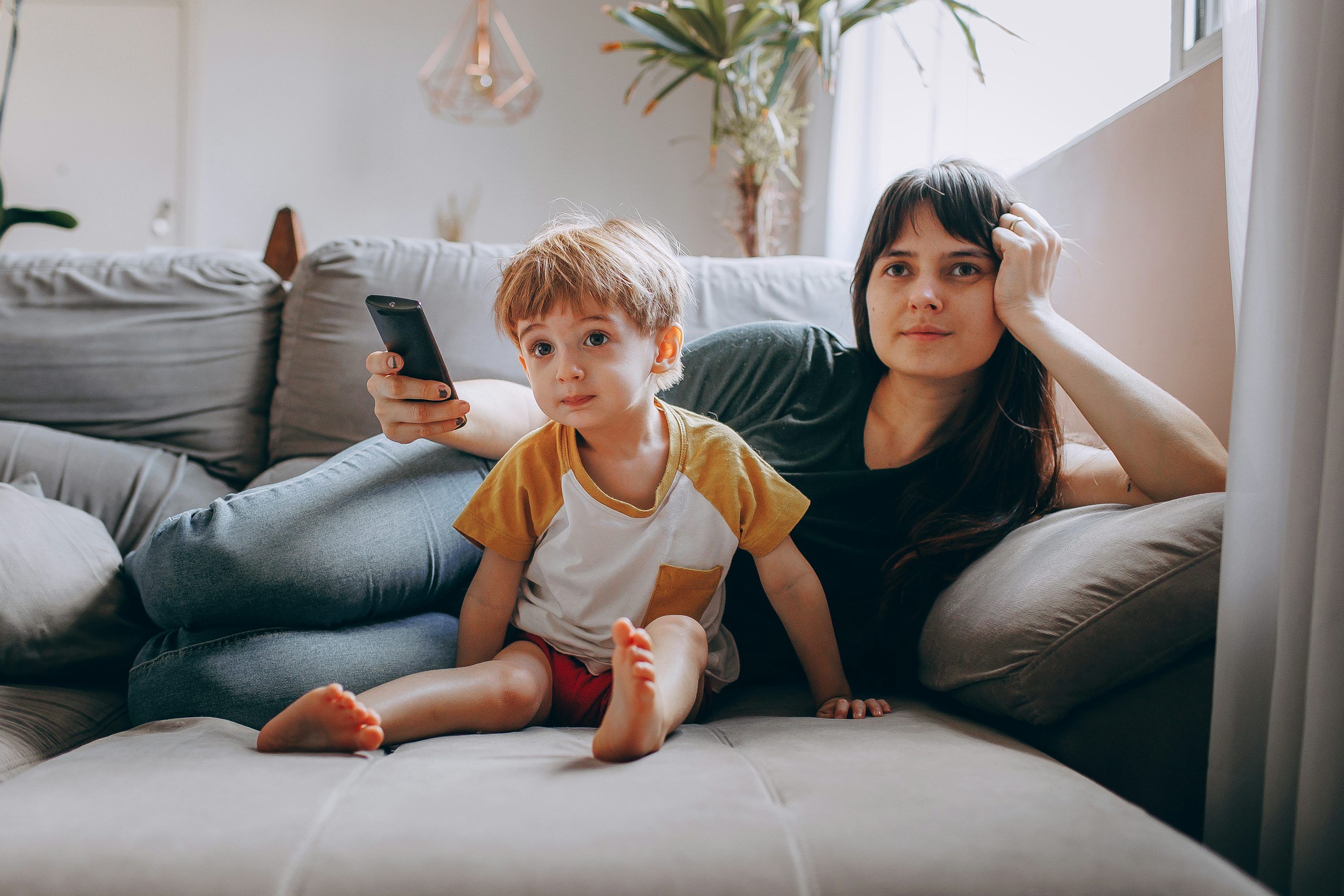 Family watching a movie on TV using a premium IPTV media player subscription with full EPG access